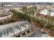 Aerial view of townhomes showcasing their rooflines, parking, and proximity to surrounding shopping and commercial areas at 763 Blossom Grove Dr, Cary, NC 27519