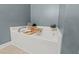 A large soaking tub features a tray to hold books and a drink at 763 Blossom Grove Dr, Cary, NC 27519