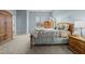 Well-lit bedroom with a wooden bed frame, soft carpet, and ample storage at 763 Blossom Grove Dr, Cary, NC 27519