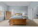 Inviting bedroom featuring a wooden bed frame, soft carpet, and natural light at 763 Blossom Grove Dr, Cary, NC 27519