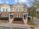 Charming townhouse featuring brick and siding exterior, well-manicured landscaping, and individual entrance with bright white railings at 763 Blossom Grove Dr, Cary, NC 27519