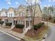 Attractive townhome with a brick facade, a landscaped front yard, and a private entrance with bright white railings at 763 Blossom Grove Dr, Cary, NC 27519