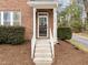 Inviting front entrance with concrete steps, white railings, and a storm door, leading to a cozy home at 763 Blossom Grove Dr, Cary, NC 27519