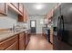 Galley kitchen featuring wood cabinets, granite countertops, and stainless steel appliances at 763 Blossom Grove Dr, Cary, NC 27519