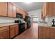 Spacious kitchen boasts wood cabinets, granite countertops, and black appliances at 763 Blossom Grove Dr, Cary, NC 27519