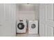Laundry room features a front loading washer and dryer with overhead storage at 763 Blossom Grove Dr, Cary, NC 27519