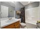 Bathroom featuring a single sink vanity, toilet, and a shower-tub combination with gray walls at 8008 Bright Oak Trl, Raleigh, NC 27616