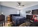 This bedroom boasts blue walls, a ceiling fan, and a bed with dark wood frame at 8008 Bright Oak Trl, Raleigh, NC 27616