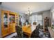 Inviting dining room with wooden table, cushioned chairs, chandelier, and wooden cabinet at 8008 Bright Oak Trl, Raleigh, NC 27616