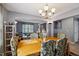 Dining room featuring a wooden table, seating, chandelier, and view into the living room at 8008 Bright Oak Trl, Raleigh, NC 27616