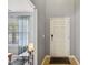Inviting foyer with a white front door, tiled floor, and gray walls creates a welcoming entryway at 8008 Bright Oak Trl, Raleigh, NC 27616