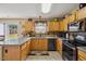 Functional kitchen with modern appliances, stone counter tops, wood cabinets, and an attached breakfast nook at 8008 Bright Oak Trl, Raleigh, NC 27616