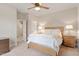 Comfortable bedroom with neutral carpet, fan, and a doorway to a dressing area at 813 Whitley Way, Wendell, NC 27591