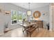 Bright dining area featuring a wooden table and chairs, hardwood floors, and a window overlooking the yard at 813 Whitley Way, Wendell, NC 27591
