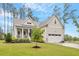 Welcoming home with a cozy front porch, an attached garage, and a well-kept lawn at 813 Whitley Way, Wendell, NC 27591