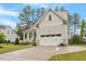Beautifully maintained home boasts an attached garage and inviting front yard landscaping at 813 Whitley Way, Wendell, NC 27591
