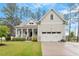 Charming home featuring a covered front porch, two-car garage, and manicured lawn at 813 Whitley Way, Wendell, NC 27591