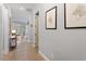 Bright hallway featuring hardwood floors and tasteful wall decor leading to various rooms in the home at 813 Whitley Way, Wendell, NC 27591