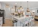 Bright kitchen features stainless steel appliances, white cabinetry, and a large center island with bar seating at 813 Whitley Way, Wendell, NC 27591