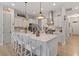 Modern kitchen with a large island, stainless steel appliances, and white cabinetry with lots of open space at 813 Whitley Way, Wendell, NC 27591