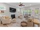 Spacious living room with a fireplace, comfortable seating, and a large ceiling fan at 813 Whitley Way, Wendell, NC 27591