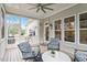 Inviting screened-in porch with comfortable seating, ceiling fan, and serene outdoor views from the multiple windows at 813 Whitley Way, Wendell, NC 27591