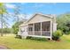 Rear exterior showcases a screened-in porch, a wooden deck, and picturesque backyard at 813 Whitley Way, Wendell, NC 27591