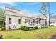 Back of house featuring screened in porch, wooden deck, green lawn, and tasteful landscaping at 813 Whitley Way, Wendell, NC 27591