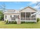 Backyard with a spacious deck, screened porch, and lush green lawn at 813 Whitley Way, Wendell, NC 27591
