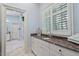 Bright bathroom with custom cabinets, marble countertop, and a view to the hall at 8904 Milden Hall Ct, Raleigh, NC 27615