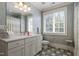 Bright bathroom featuring tiled floors, spacious vanity with cabinets, and a shower tub combo at 8904 Milden Hall Ct, Raleigh, NC 27615