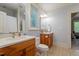 Bathroom featuring wooden vanities, with double sinks and an adjacent toilet at 8904 Milden Hall Ct, Raleigh, NC 27615