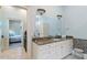Bathroom with an elegant vanity, unique sconces, and view into the main bedroom at 8904 Milden Hall Ct, Raleigh, NC 27615