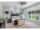 Bright bedroom with large windows, a ceiling fan, and a comfortable king-size bed at 8904 Milden Hall Ct, Raleigh, NC 27615