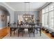 Formal dining room boasts ample natural light, a stylish chandelier, and seating for eight at 8904 Milden Hall Ct, Raleigh, NC 27615