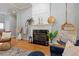 Living room fireplace with decorative mantel, ladder, and hanging chair at 8904 Milden Hall Ct, Raleigh, NC 27615