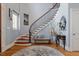 Elegant foyer with a curved staircase, hardwood floors, and a decorative rug at 8904 Milden Hall Ct, Raleigh, NC 27615