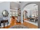Grand foyer features hardwood floors, arched doorways, and elegant decor leading to the dining and living spaces at 8904 Milden Hall Ct, Raleigh, NC 27615