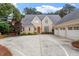 Beautiful brick home with a basketball court and three-car garage on a sunny day at 8904 Milden Hall Ct, Raleigh, NC 27615