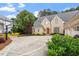 Brick home with a driveway basketball court, well-manicured landscaping and a three-car garage at 8904 Milden Hall Ct, Raleigh, NC 27615