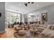 Cozy living room boasts hardwood floors, a large window, and a decorative area rug at 8904 Milden Hall Ct, Raleigh, NC 27615