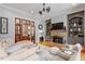 Inviting living room with a fireplace, built-in shelves, and wood floors at 8904 Milden Hall Ct, Raleigh, NC 27615