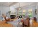 Bright living room featuring a fireplace, built-in shelving, large windows, and access to the backyard at 8904 Milden Hall Ct, Raleigh, NC 27615