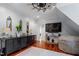 Comfortable living area featuring built in cabinets, hardwood floors, and a unique windmill ceiling fan at 8904 Milden Hall Ct, Raleigh, NC 27615