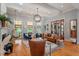 Airy living room with a hanging chair, fireplace, and a comfortable seating arrangement at 8904 Milden Hall Ct, Raleigh, NC 27615