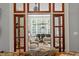 Sunlit Gathering room featuring hardwood floors and french doors leading to a patio at 8904 Milden Hall Ct, Raleigh, NC 27615