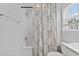 Bright and airy bathroom featuring a shower-tub combination with a stylish shower curtain and a modern toilet at 8925 Lee Brown Ridge Dr, Wake Forest, NC 27587