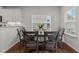 Bright dining area featuring a dark wood table, seating for six, and natural light at 8925 Lee Brown Ridge Dr, Wake Forest, NC 27587