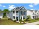 Charming blue two-story home featuring a balcony, landscaped front yard, and classic architectural details at 8925 Lee Brown Ridge Dr, Wake Forest, NC 27587