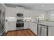 Well-lit kitchen featuring stainless steel appliances, granite countertops, and white cabinetry at 8925 Lee Brown Ridge Dr, Wake Forest, NC 27587